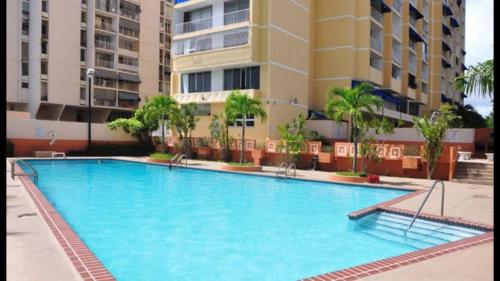 a large swimming pool in front of a building at Isla Verde Puerto Rico, Two Full Beds in San Juan