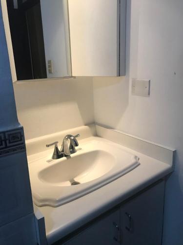 a bathroom with a sink and a mirror at Isla Verde Puerto Rico, Two Full Beds in San Juan