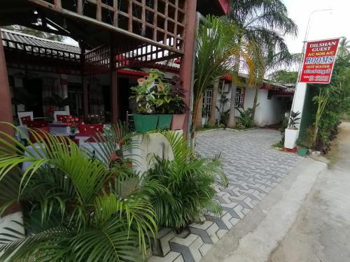 a building with a courtyard with plants in front of it at Dilshan Guest in Polonnaruwa