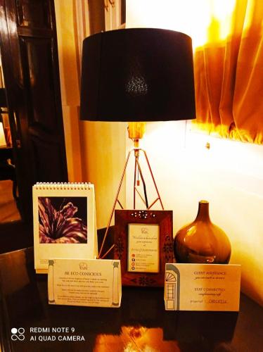 a table with a lamp and other items on it at Ranjit's Svaasa Amritsar in Amritsar