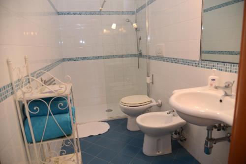 a bathroom with a toilet and a sink at Jonico Guest House in Scanzano