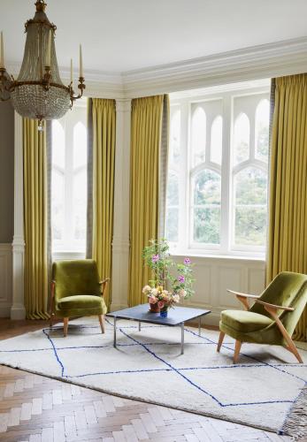a living room with two chairs and a coffee table at Oakley Court in Windsor