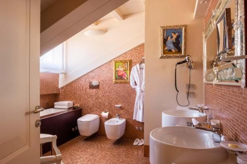
a bathroom with a toilet, sink, and bathtub at Hotel Moresco in Venice
