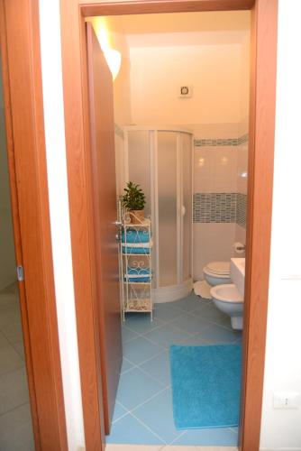 a bathroom with a toilet and a sink at Jonico Guest House in Scanzano