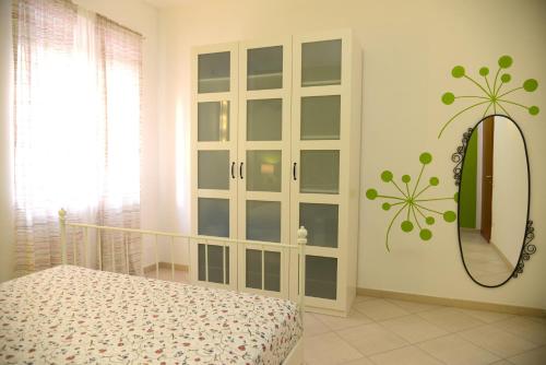 a bedroom with a mirror and a bed in a room at Jonico Guest House in Scanzano