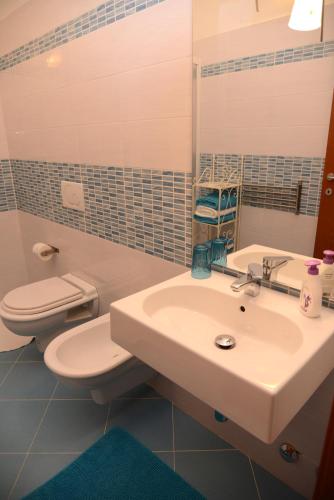 a bathroom with a sink and a toilet at Jonico Guest House in Scanzano