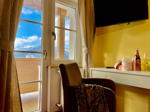 a room with a window with a view of a mountain at Waldhotel Seefeld in Seefeld in Tirol