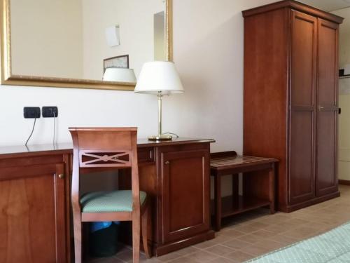 a room with a desk with a lamp and a chair at Hotel Villa Peretti in Gela