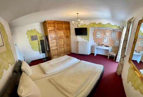 a bedroom with a bed and a desk in it at Waldhotel Seefeld in Seefeld in Tirol