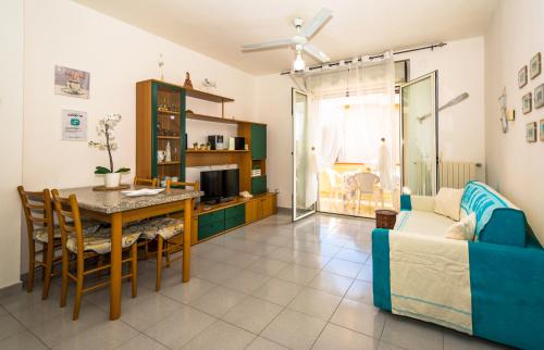 a living room with a table and a couch at Sardinia-holiday casa Pesce Palla in La Maddalena