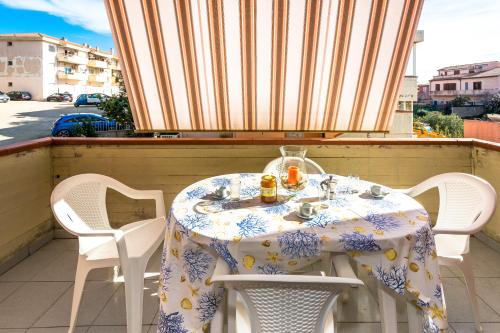 a table and chairs sitting on a balcony at Sardinia-holiday casa Pesce Palla in La Maddalena