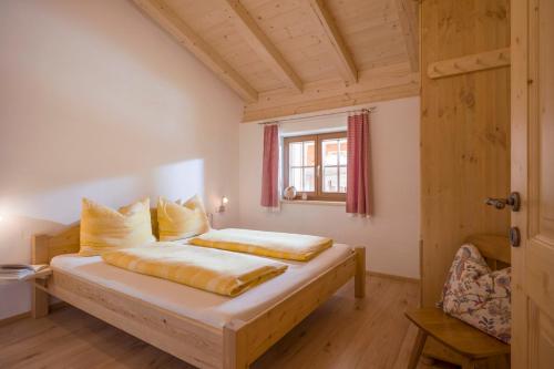 a bedroom with a bed in a room with a window at Oberfasser in Westendorf