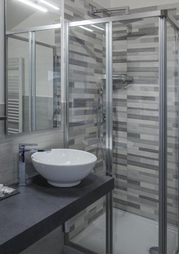 a bathroom with a white sink on a counter at Le Stanze dei Fiori in Bologna