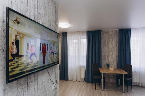 a living room with a large painting on the wall at Apart-hotel I. Sirko New Building 8 floor in Sumy