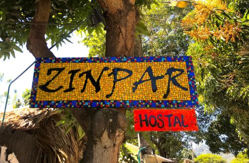 a sign on a tree that reads emergency hospital at Casa Zinpar in Palomino