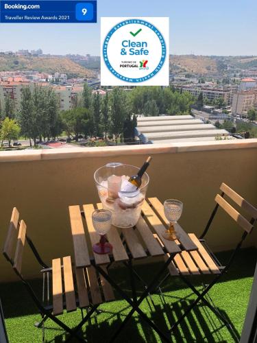 a table with a bowl of ice cream and wine glasses at Boa Vista Apartamento in Odivelas
