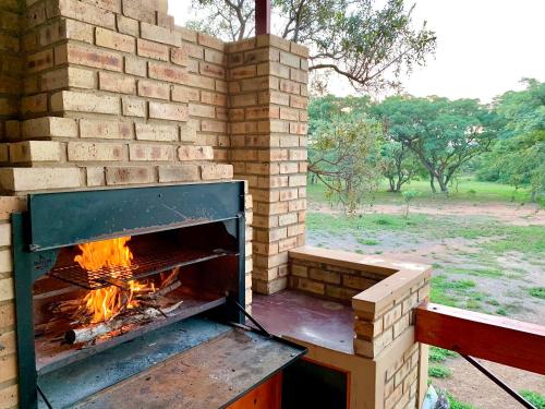 a brick oven with a fire inside of it at Muqurati Lodge - Dinokeng Game Reserve in Klipdrift