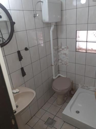 a white bathroom with a toilet and a sink at Kuca za odmor Zlatibor in Zlatibor