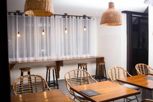 a dining room with wooden tables and chairs at ELOGIA HOTEL in Lomé