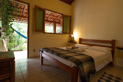 Een bed of bedden in een kamer bij Pousada Rosa dos Ventos