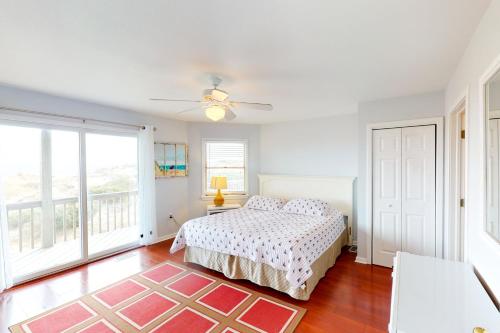 a bedroom with a bed and a large window at Poetry in Motion #7-K in Avon