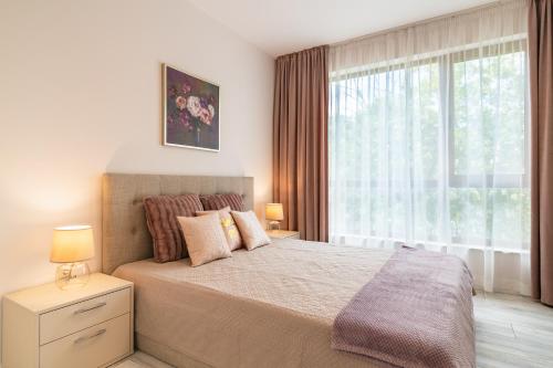 A bed or beds in a room at La Mer Residence