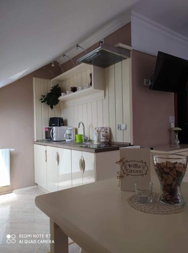a kitchen with white cabinets and a counter top at Willa Grono in Krościenko