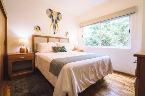a bedroom with a large bed and a window at The Gallery in Mexico City