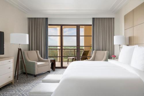 a hotel room with a bed and a balcony at Four Seasons Resort Orlando at Walt Disney World Resort in Orlando