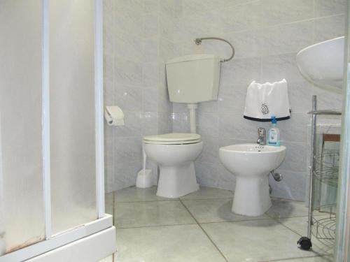 a bathroom with a toilet and a sink at Casa Relax in Villasimius