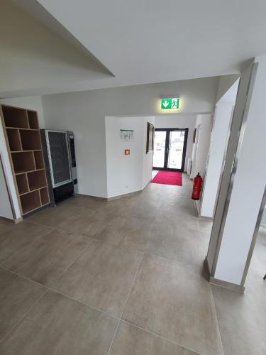 an empty room with a tile floor and white walls at Hotel zur Traube in Möglingen