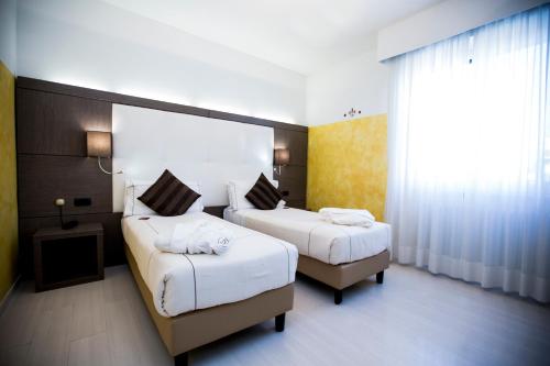 Ένα ή περισσότερα κρεβάτια σε δωμάτιο στο Agape Hotel AA Hotels