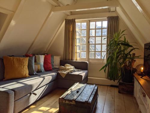 a living room with a couch and a window at StoreStay DamSquare in Amsterdam