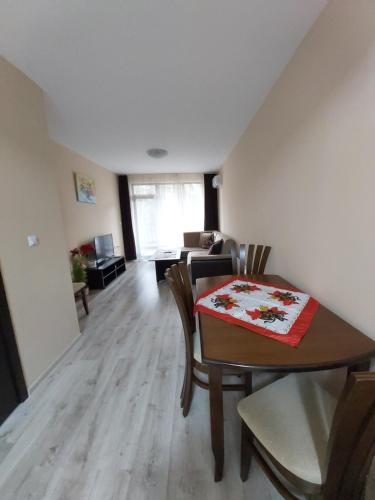 a living room with a table and chairs and a couch at Apartment Krasi in Velingrad