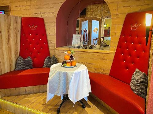 a room with a table and two red chairs at Meister BÄR HOTEL Fichtelgebirge in Marktredwitz