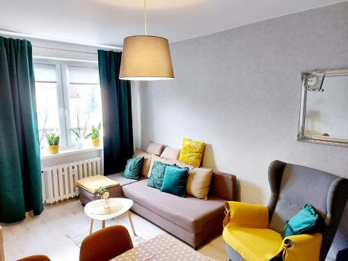 a living room with a couch and two chairs at Apartament Wągrowiec, Gabi - Remigiusz Kiszka in Wągrowiec