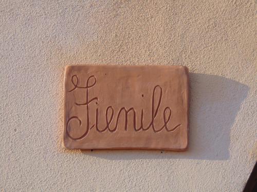a brown sign on a wall with the word flannel at Resort Casale Le Torri in Ponsacco