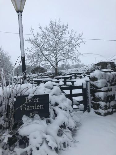 a sign for the elder garden covered in snow at Queens Arms Litton in Litton