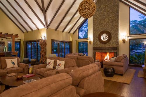 a large living room with couches and a fireplace at The Retreat at Ngorongoro in Karatu