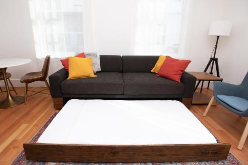 a living room with a couch with colorful pillows at South Main Residences by Surf Hotel in Buena Vista