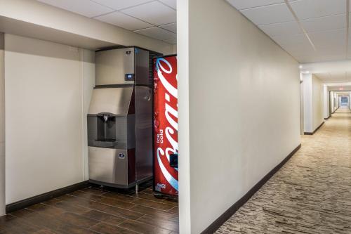 a hallway with a coke cola vending machine at Red Roof Inn PLUS+ Boston - Woburn/ Burlington in Woburn