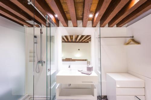 a bathroom with a glass shower and a sink at Domingo Santo Hotel Boutique in Mexico City