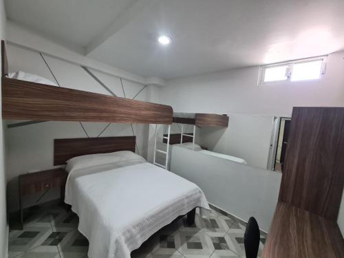 a small bedroom with a bed and a tub at Hotel Town Express in Durango