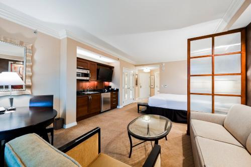 a hotel room with a bed and a living room at Penthouse Suite with Strip View at The Signature At MGM Grand in Las Vegas