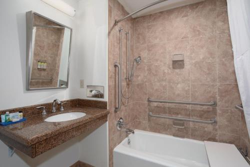 a bathroom with a sink and a shower at Holiday Inn Express Hotel & Suites Lander by IHG in Lander