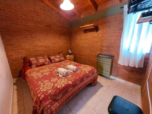 a bedroom with a bed with two pillows on it at Las Retamas - Viviendas Turísticas in Zapala
