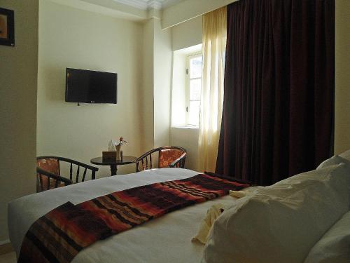 Postel nebo postele na pokoji v ubytování Hotel Riad Ben Atar