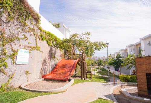a orange bench sitting next to a building at CASA EN PRIVADA FRENTE A LA PLAYA CON ALBERCA! in Mazatlán