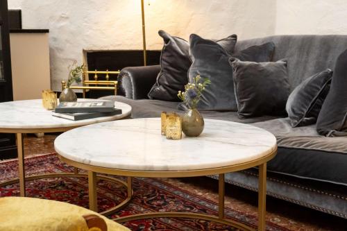a living room with two tables and a couch at Best Western Hotel Bentleys in Stockholm