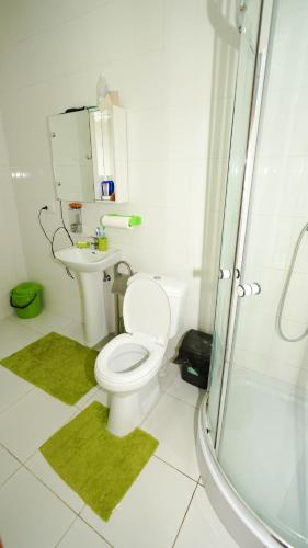 a white bathroom with a toilet and a shower at City Hostel Panorama in Uzhhorod